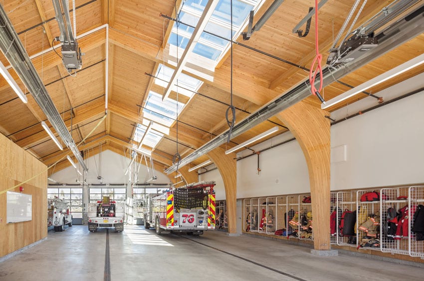 Fire Station 76 mass timber ceiling, fire engines, and lockers