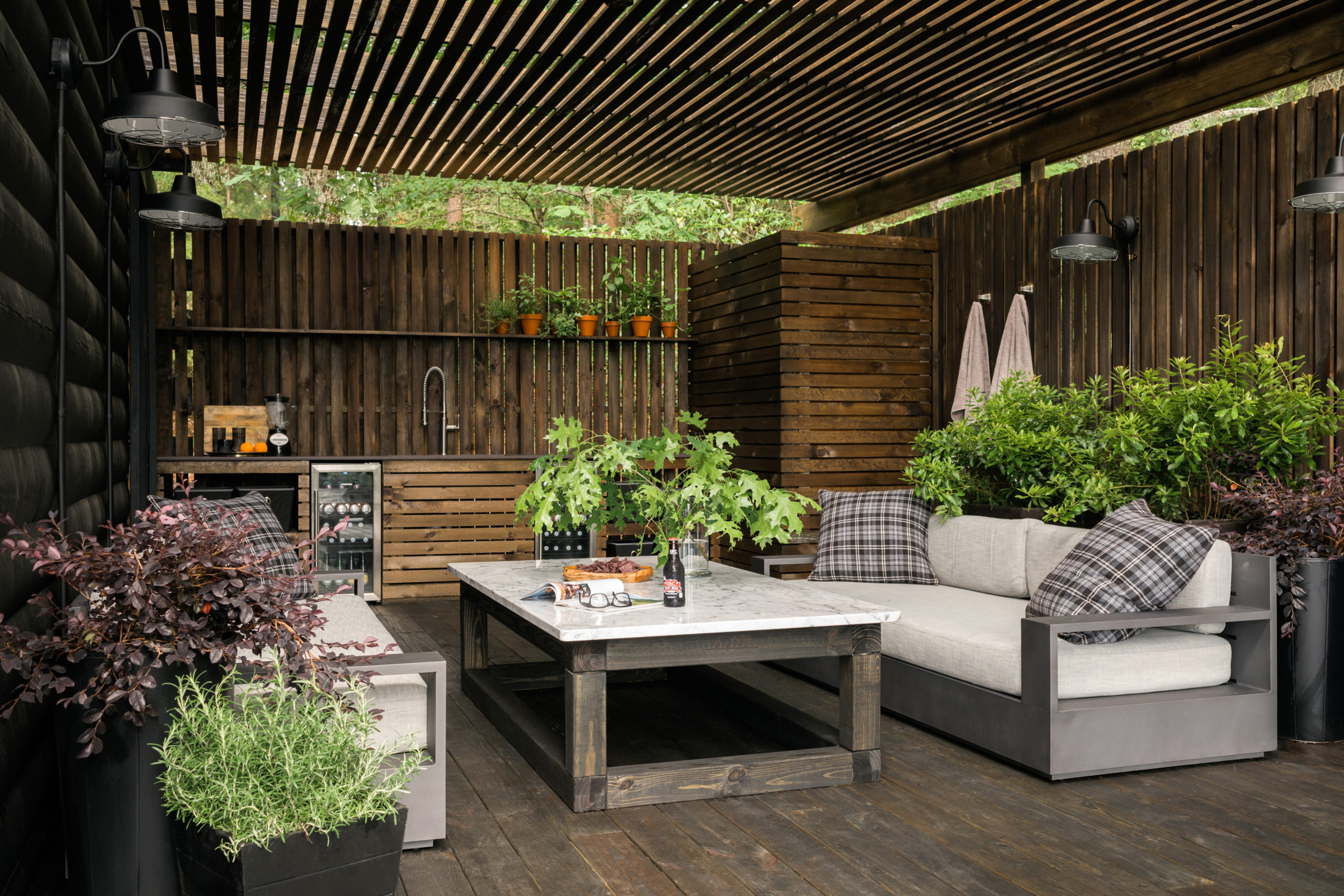 Rustic wood seating area with bar and outdoor shower