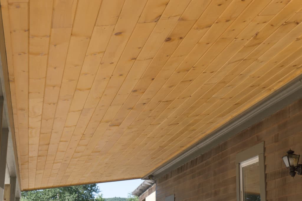A wooden ceiling on the outside of a home