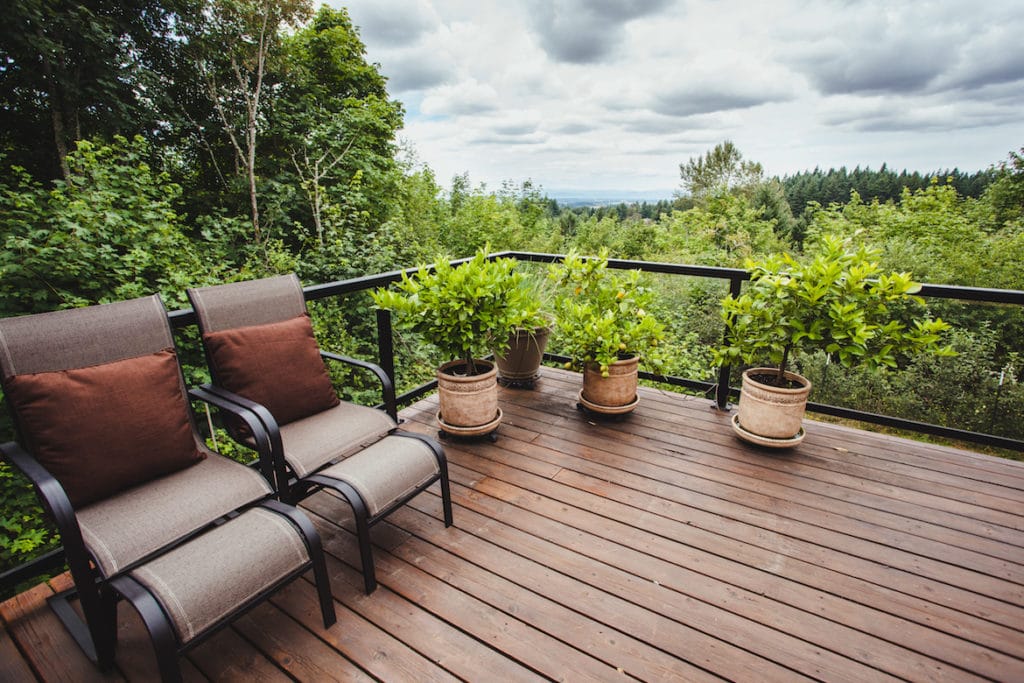 A wooden deck with plants and greenery
