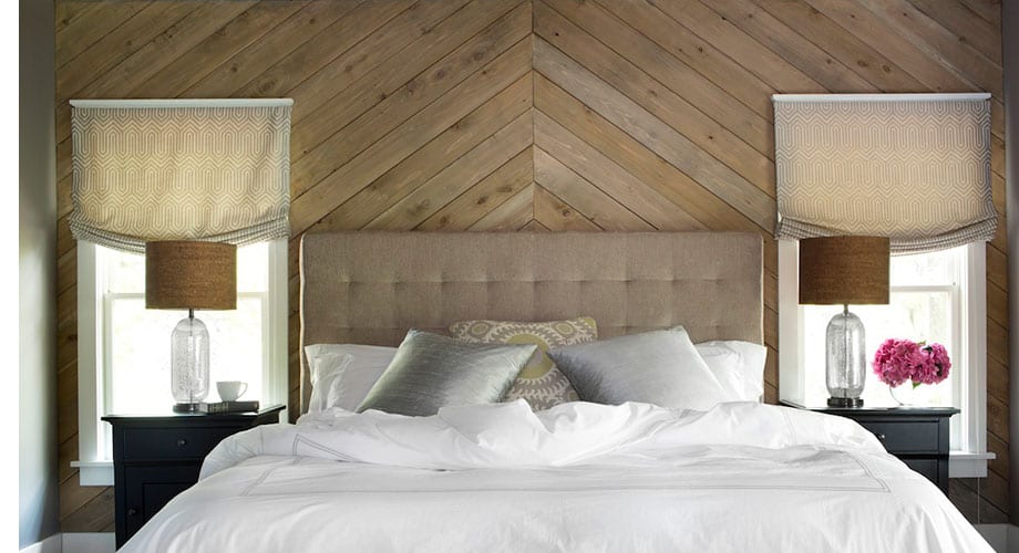A wooden wall behind the bed