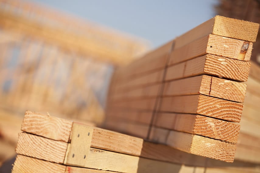 Stacks of softwood building lumber at construction site